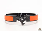 Premium collection band style bracelet in matt orange with black metallic details and black T alphabet motif