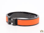 Premium collection band style bracelet in matt orange with black metallic details and black T alphabet motif