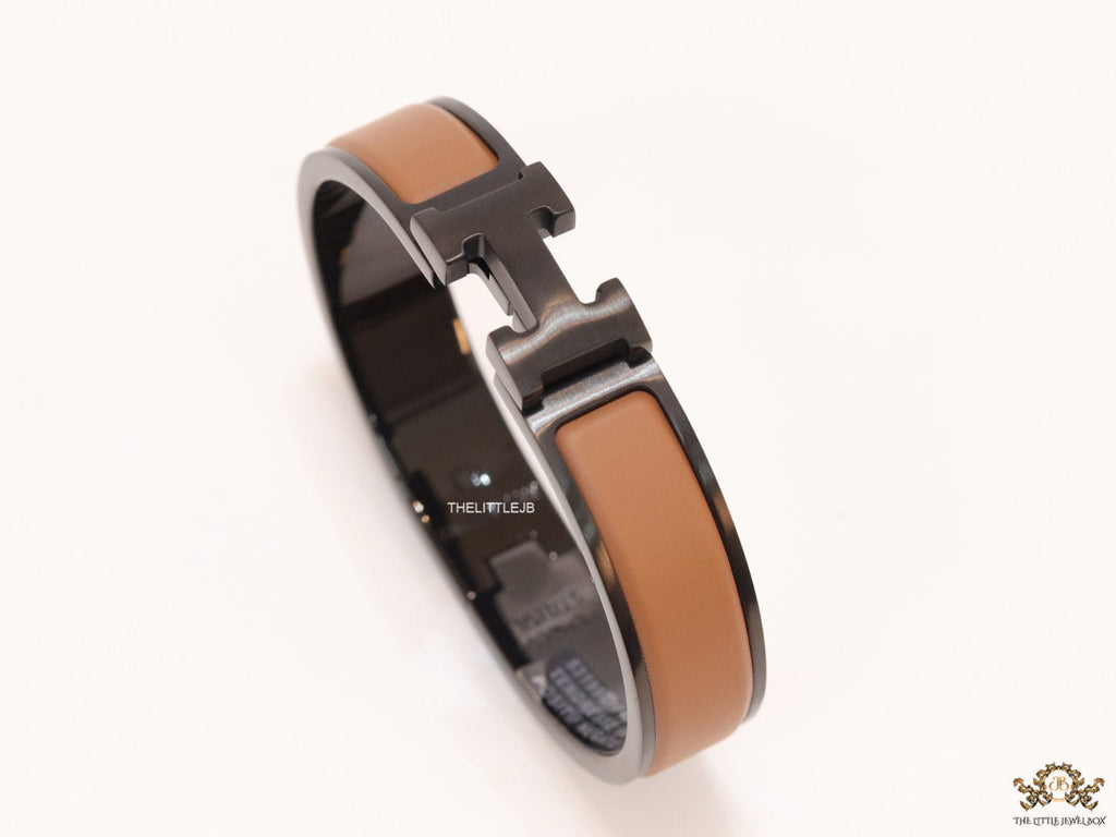 Premium collection band style bracelet in matt tan with black metallic details and black T alphabet motif