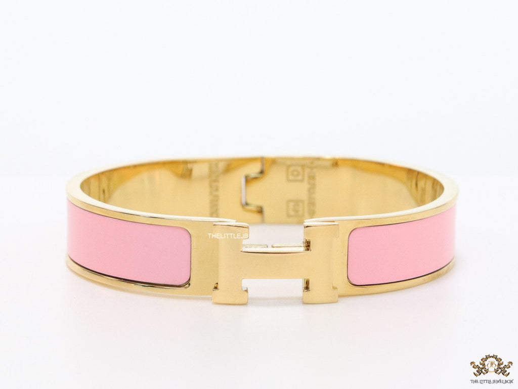 Premium range band style bracelet in pink colour with gold plated metallic details and gold plated T alphabet motif