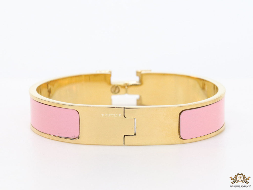 Premium range band style bracelet in pink colour with gold plated metallic details and gold plated T alphabet motif