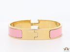Premium range band style bracelet in pink colour with gold plated metallic details and gold plated T alphabet motif