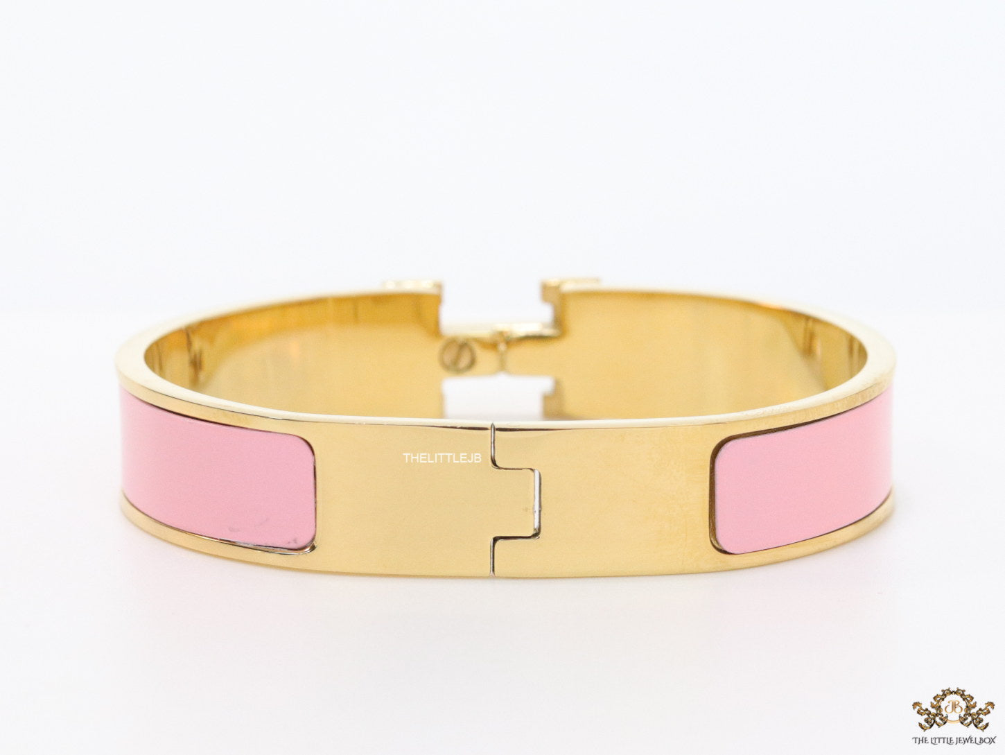 Premium range band style bracelet in pink colour with gold plated metallic details and gold plated T alphabet motif