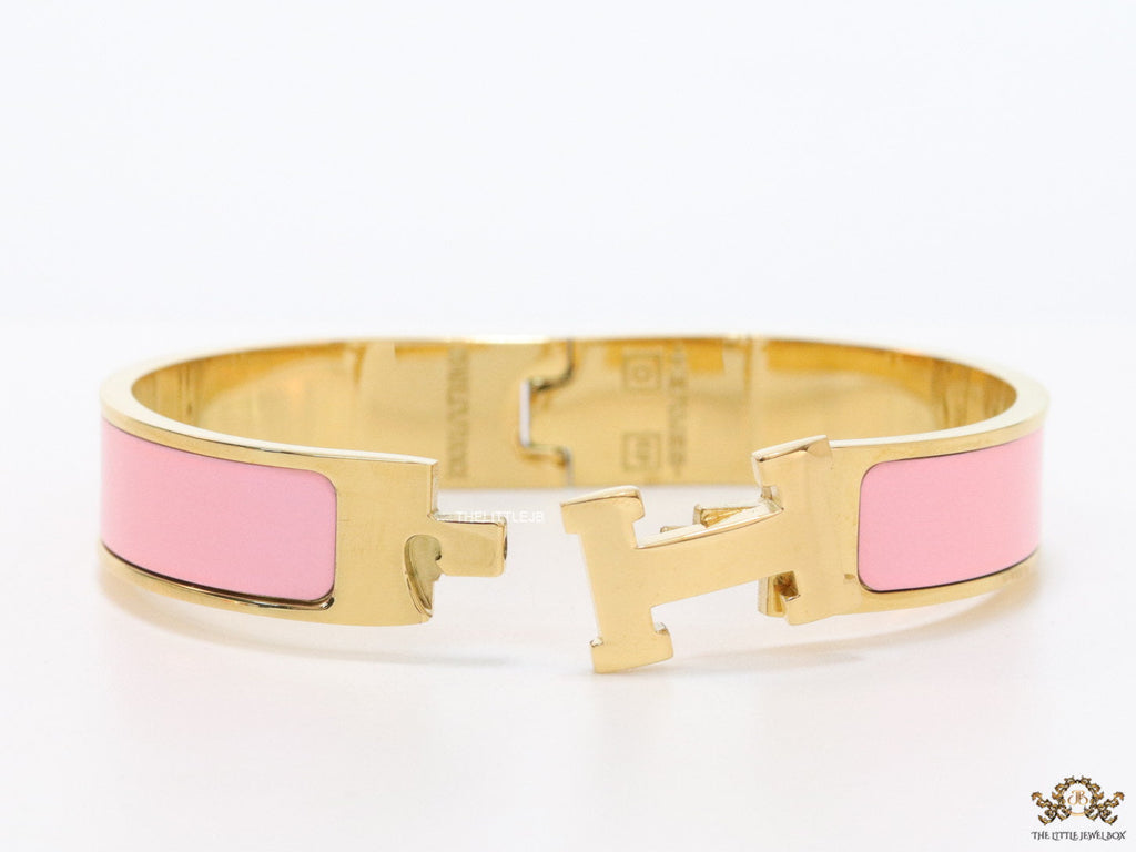 Premium range band style bracelet in pink colour with gold plated metallic details and gold plated T alphabet motif