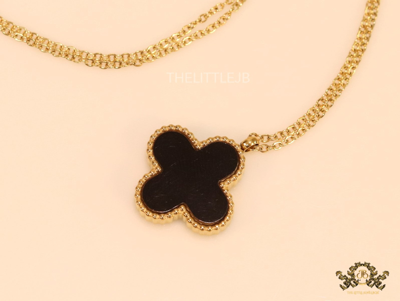 Gold plated chain with black onyx clover pendant