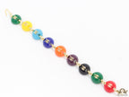 Gold plated link chain bracelet with multi coloured acrylic buttons with gold plated twin C alphabet