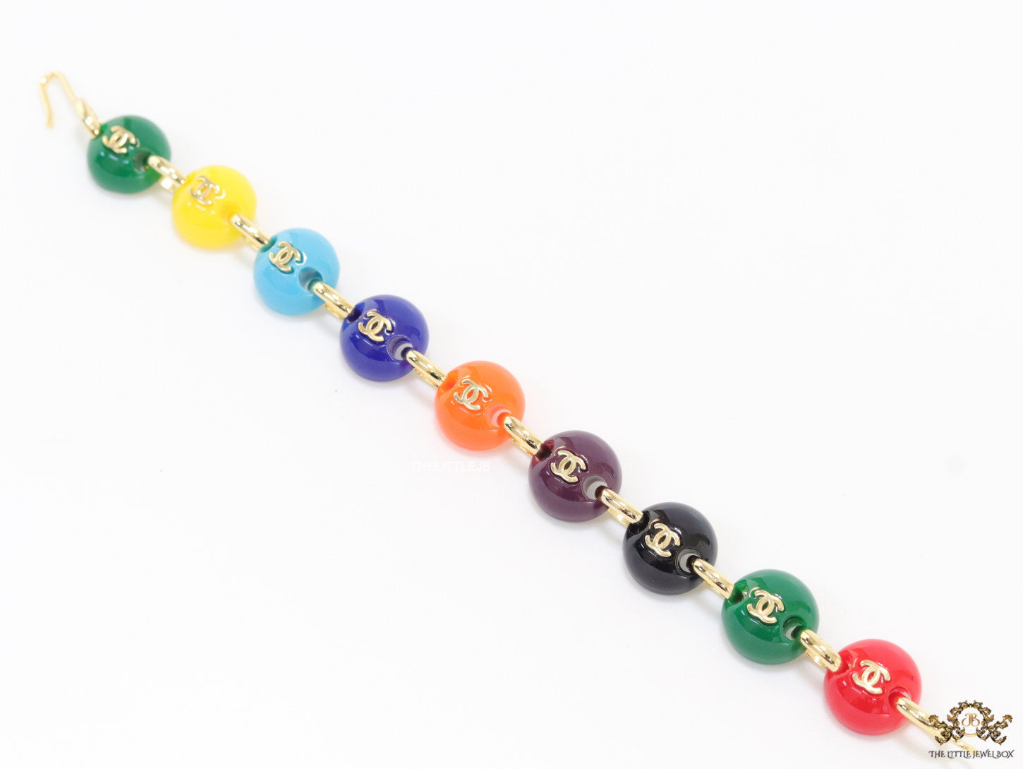 Gold plated link chain bracelet with multi coloured acrylic buttons with gold plated twin C alphabet