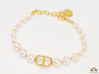 White pearl bracelet with gold plated alphabet motif