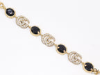 Gold plated linked chain bracelet with black stones and twin G alphabet motif