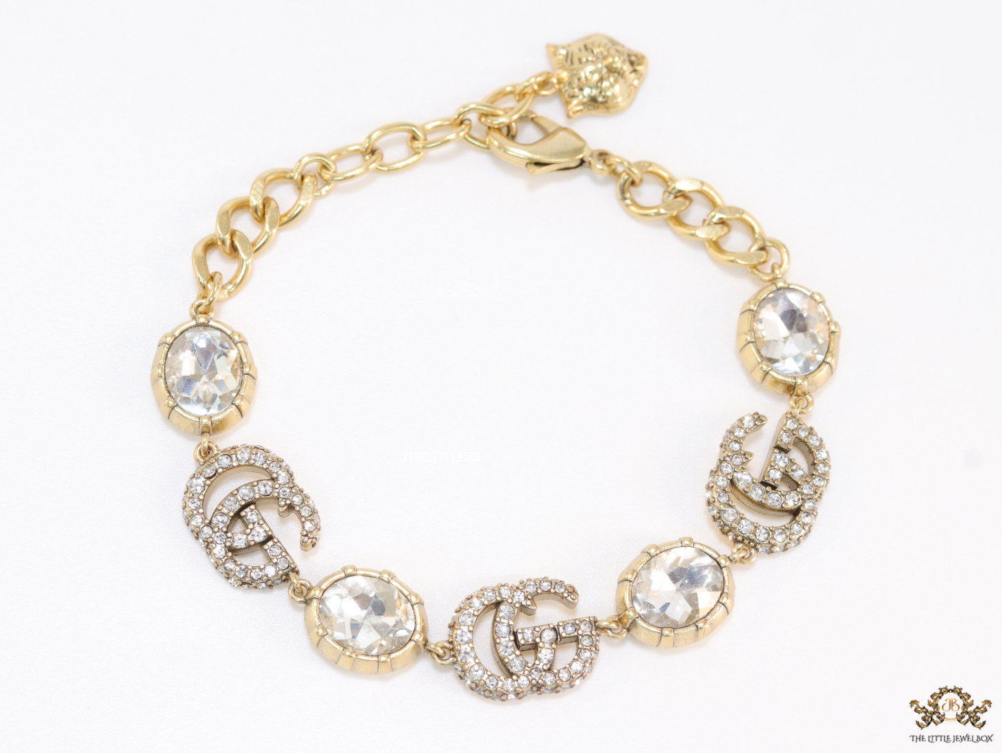 Gold plated linked chain bracelet with gold plated cubic zirconia stones twin G alphabet motifs and gold plated cubic zirconia stones