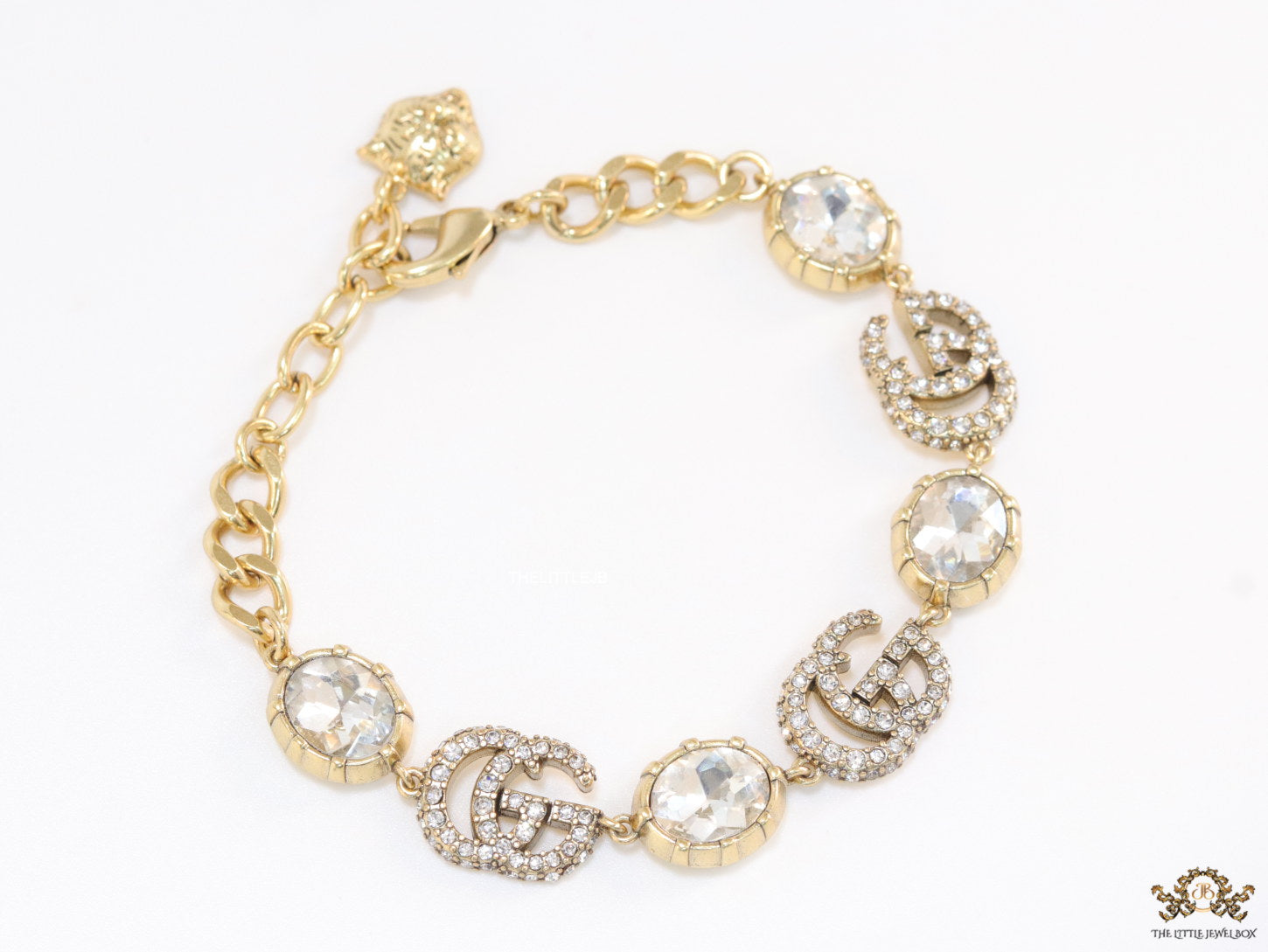 Gold plated linked chain bracelet with gold plated cubic zirconia stones twin G alphabet motifs and gold plated cubic zirconia stones
