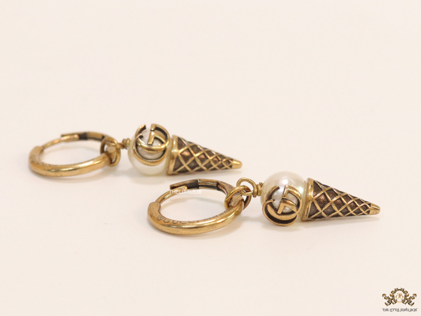 Small gold plated hoops with twin G and softy drops