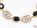 Gold plated linked chain bracelet with black stones and twin G alphabet motif