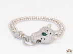 Platinum plated bracelet with cubic zirconia stones panther face motif with green cubic zirconia stone details and cubic zirconia stones disc