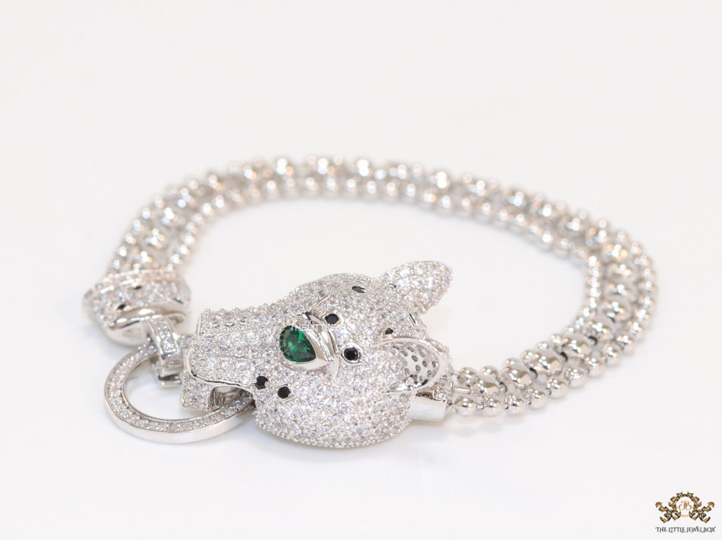 Platinum plated bracelet with cubic zirconia stones panther face motif with green cubic zirconia stone details and cubic zirconia stones disc