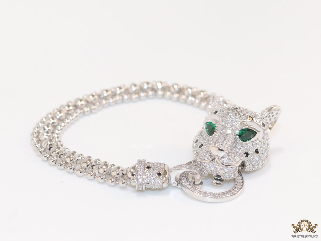 Platinum plated bracelet with cubic zirconia stones panther face motif with green cubic zirconia stone details and cubic zirconia stones disc