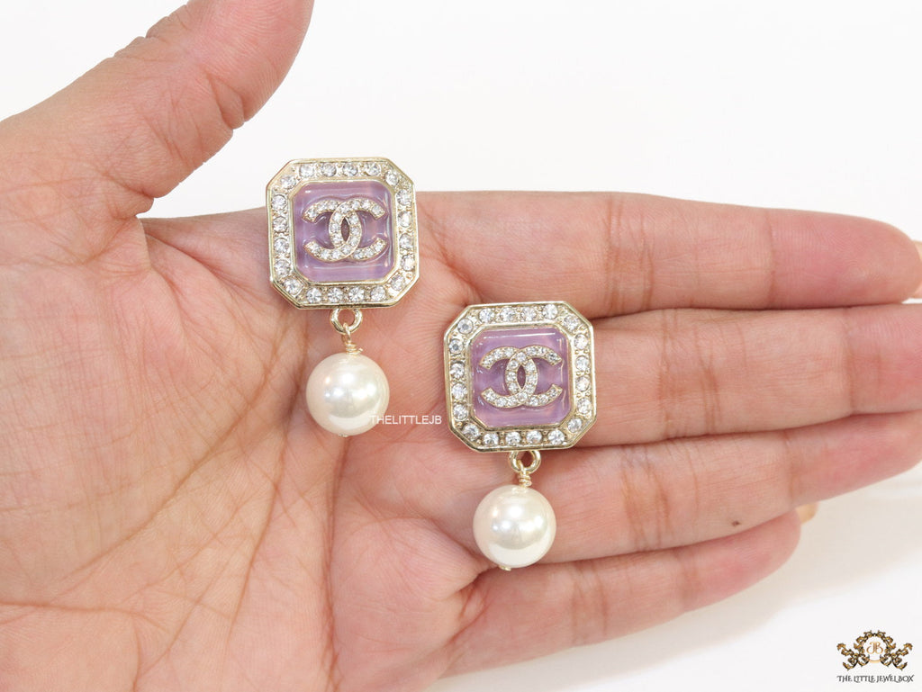 Purple pearl drop earrings with twin C motif in cz