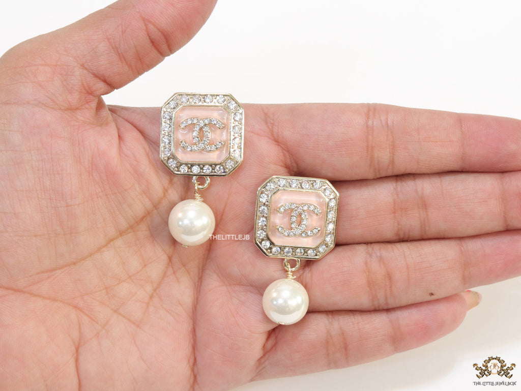 Light pink pearl drop earrings with twin C motif in cz