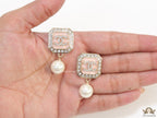 Light pink pearl drop earrings with twin C motif in cz