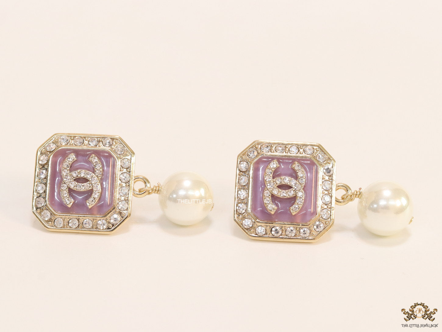 Purple pearl drop earrings with twin C motif in cz