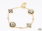 Sleek gold plated chain style bracelet with gold plated grey mother of pearl flower designs