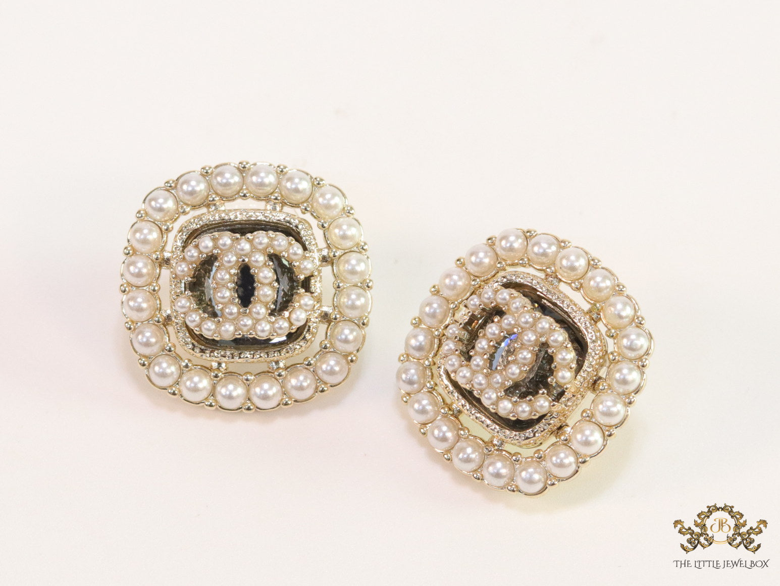 Pearl and cz studs with twin C motif