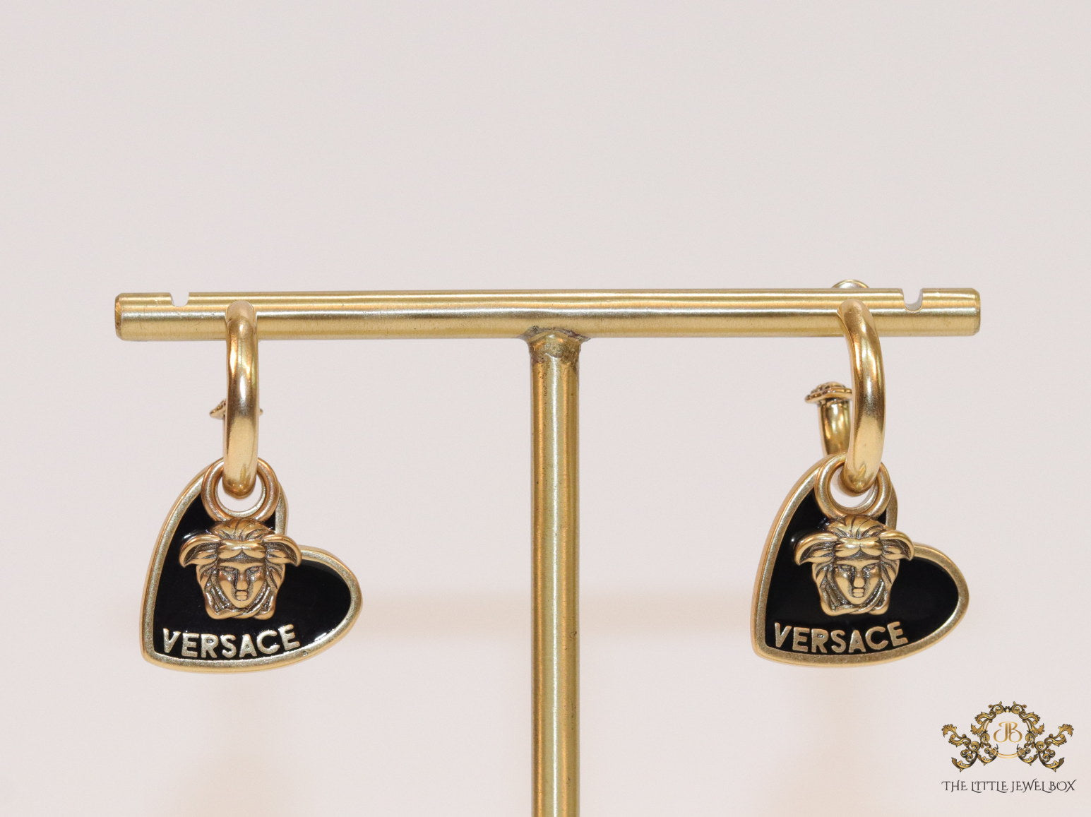 Golden and black enamel heart shape medusa earrings