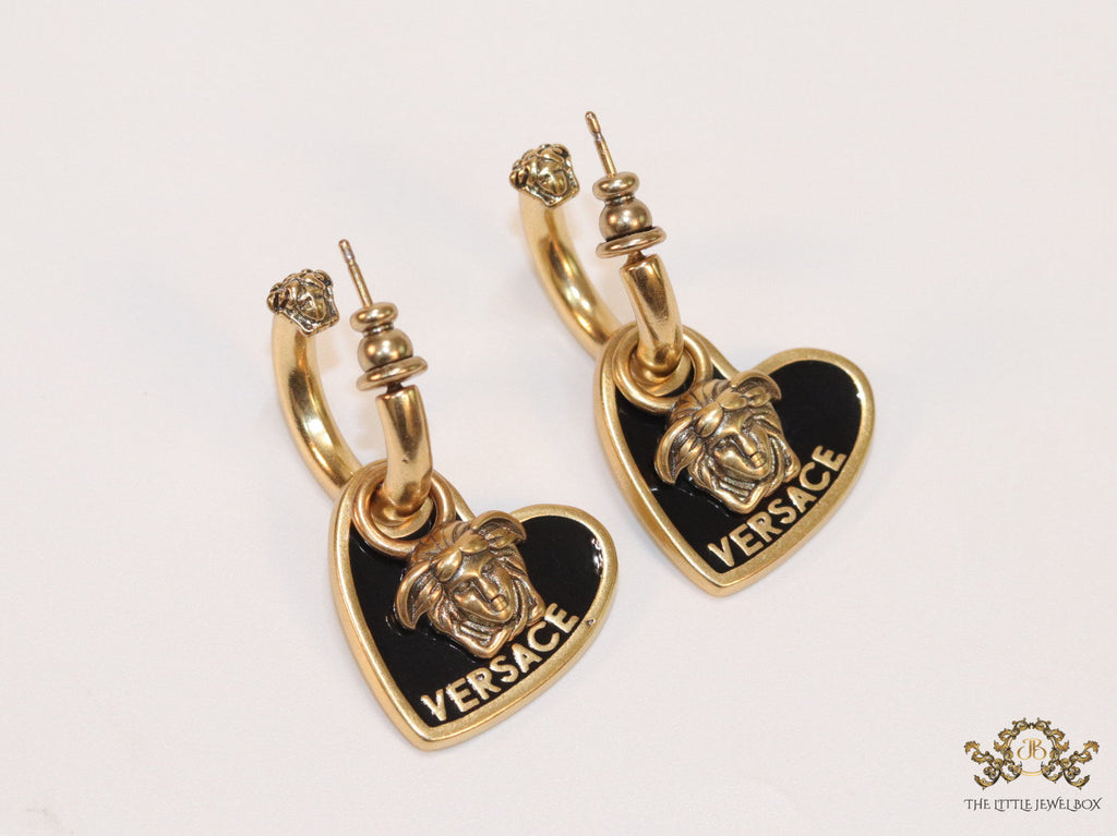 Golden and black enamel heart shape medusa earrings