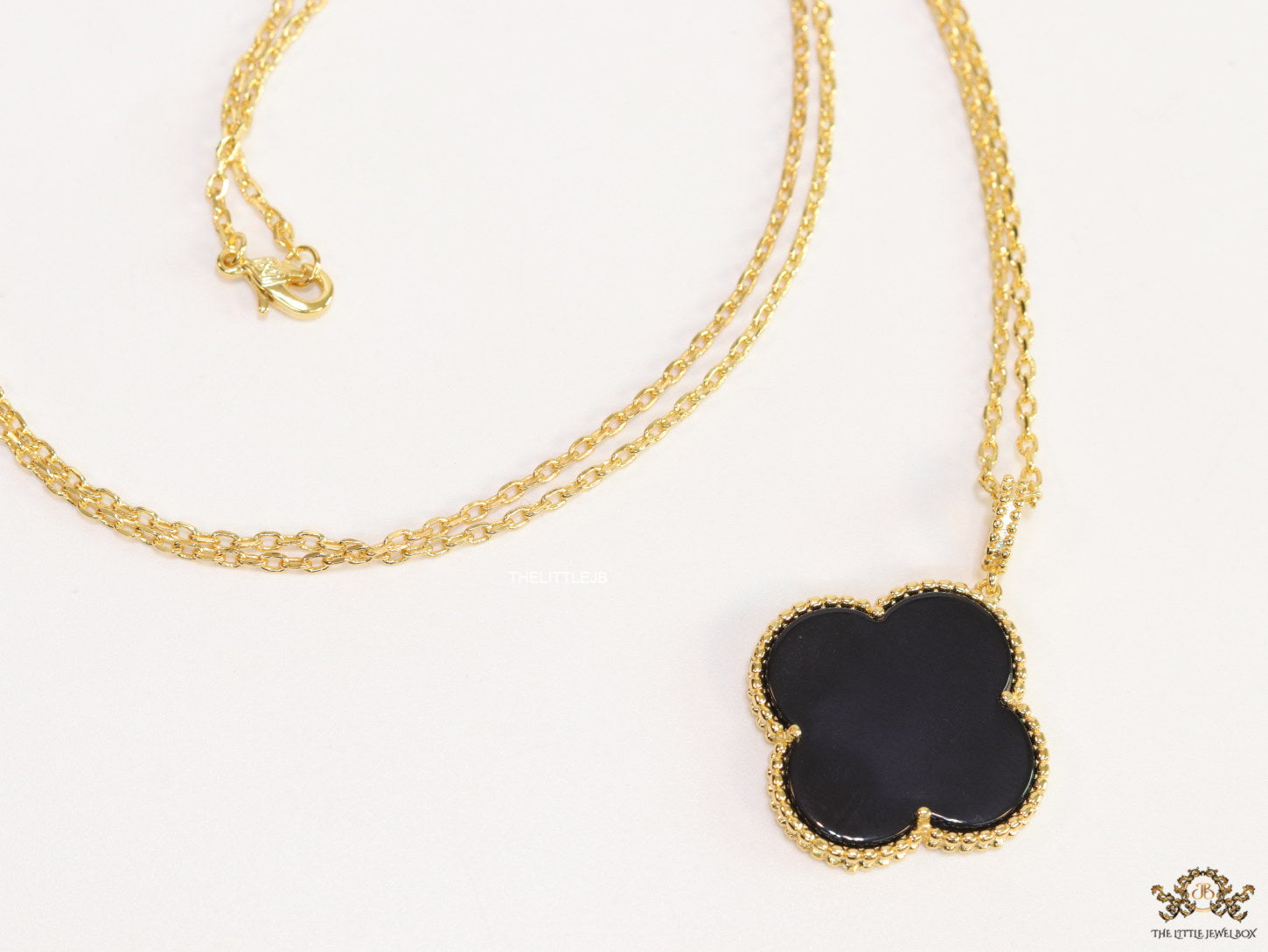 Black enamel clover pendant in gold plated chain
