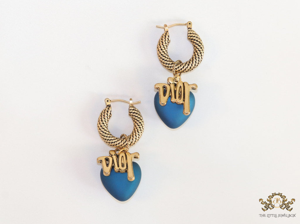 Golden hoops with alphabets and blue pearl drop