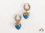Golden hoops with alphabets and blue pearl drop