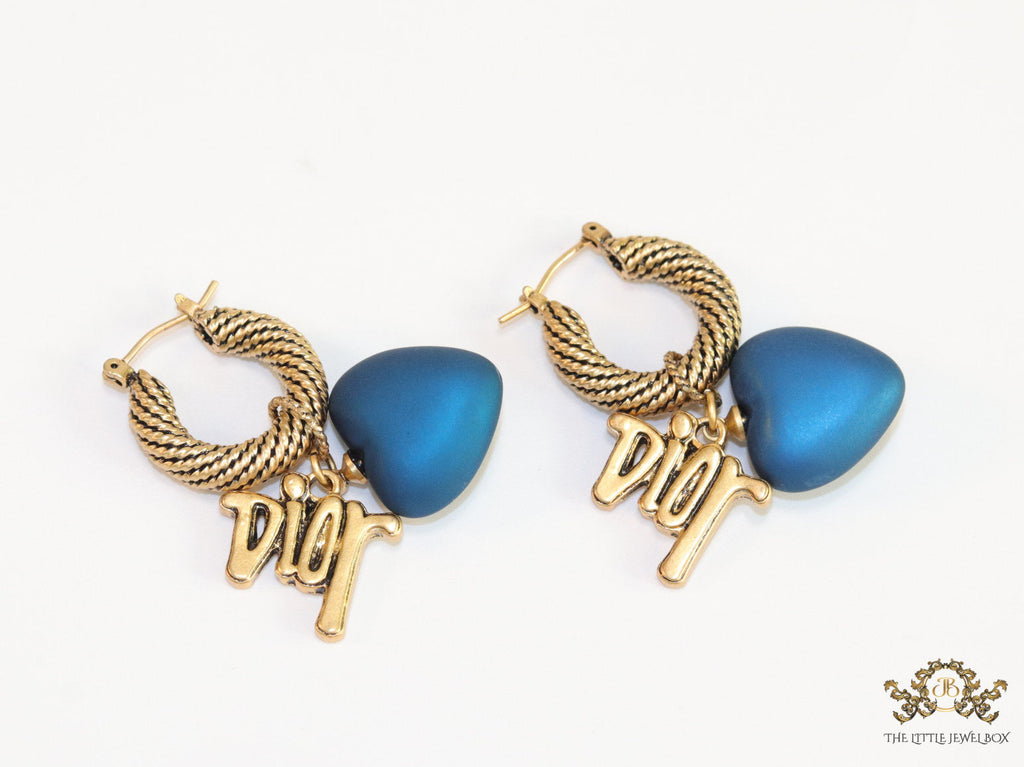 Golden hoops with alphabets and blue pearl drop