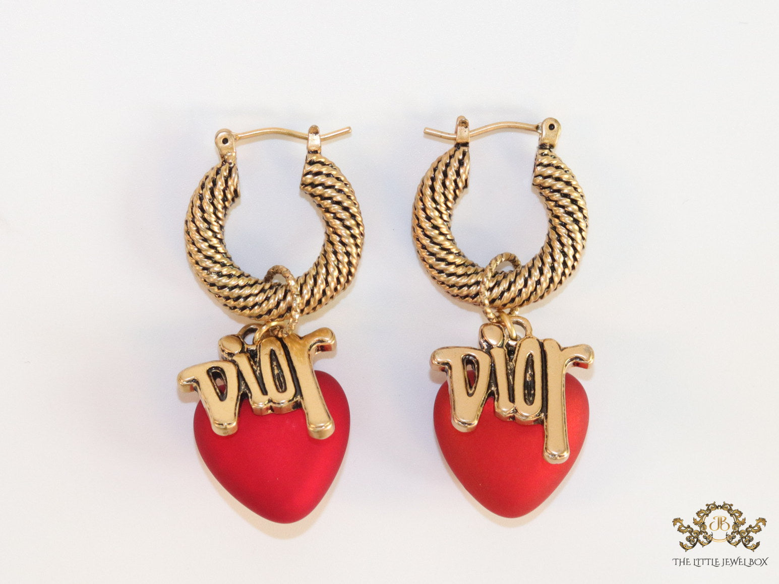 Golden hoops with alphabets and red pearl drop