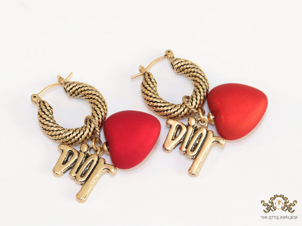 Golden hoops with alphabets and red pearl drop