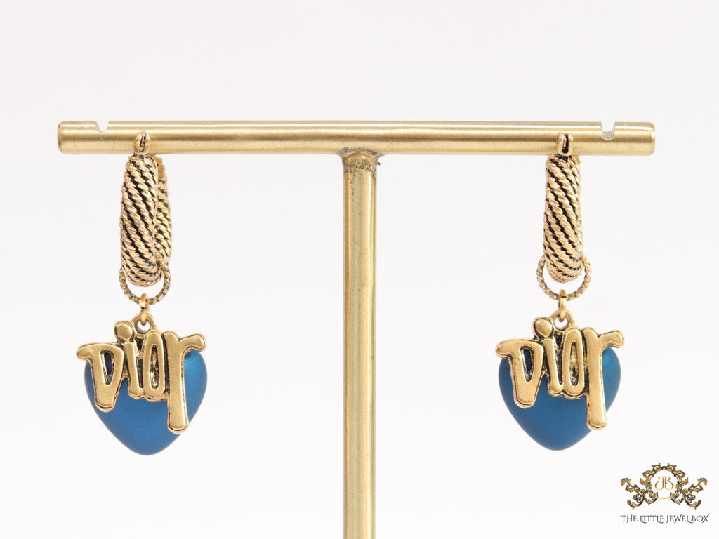 Golden hoops with alphabets and blue pearl drop