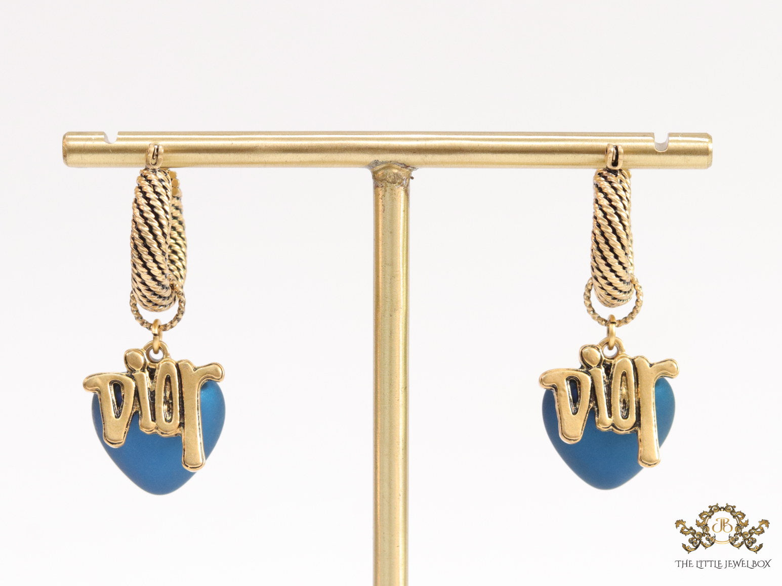 Golden hoops with alphabets and blue pearl drop