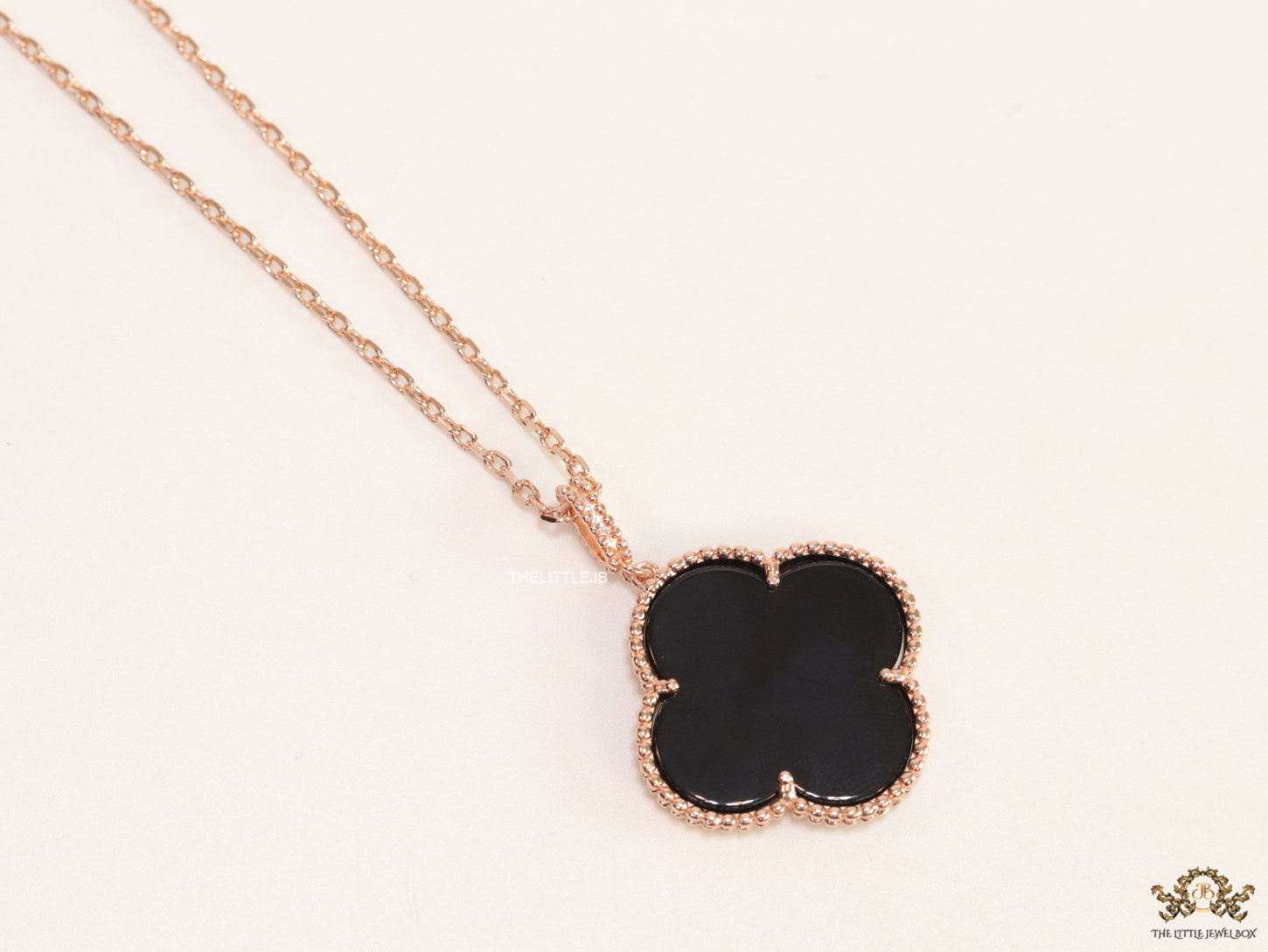 Black enamel clover pendant in rose gold plated chain