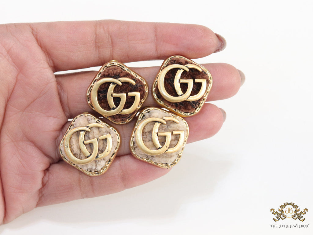 Cream velvet fur studs with golden twin G motif