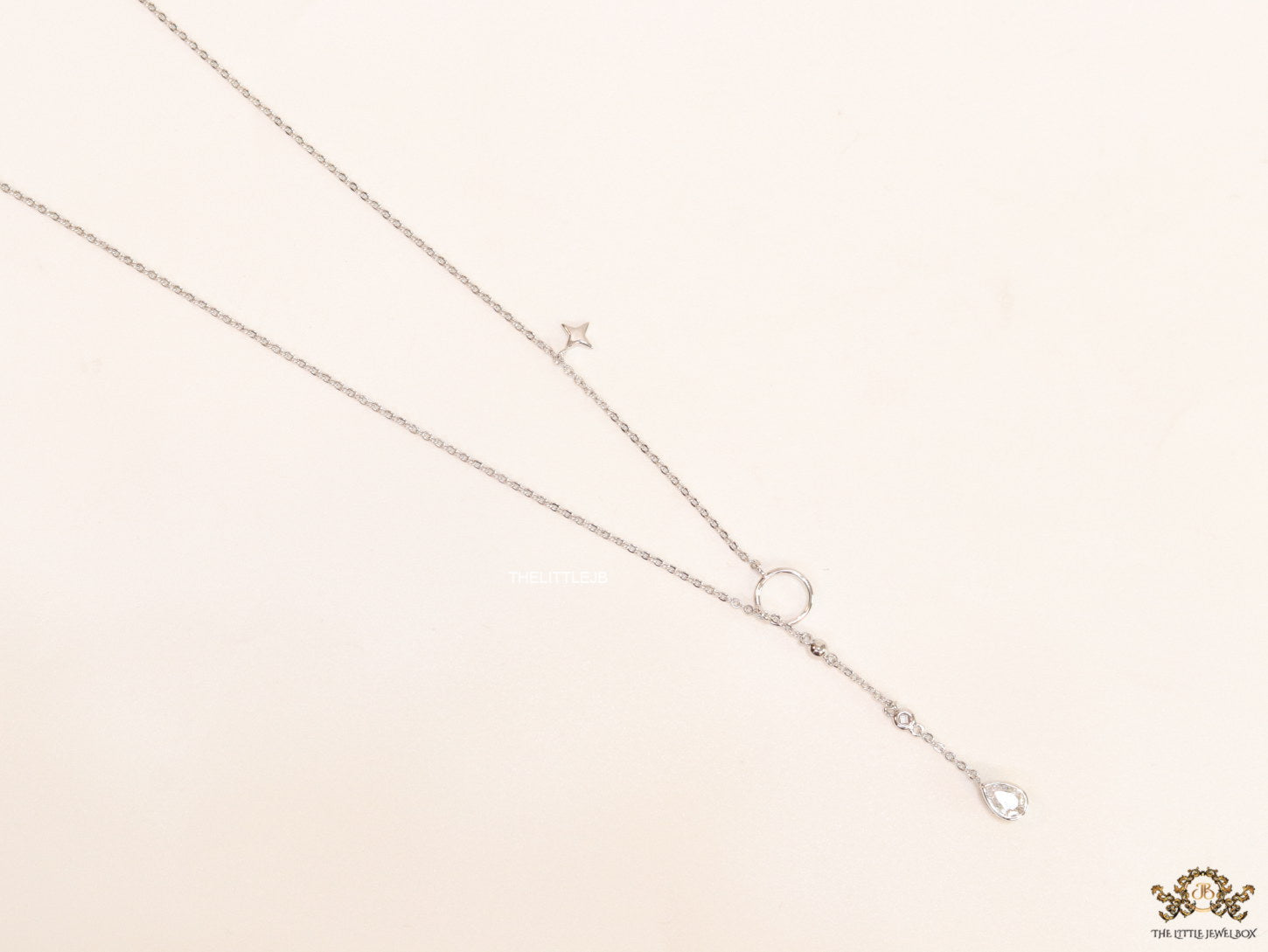 Platinum knot necklace with cz drop and small charms