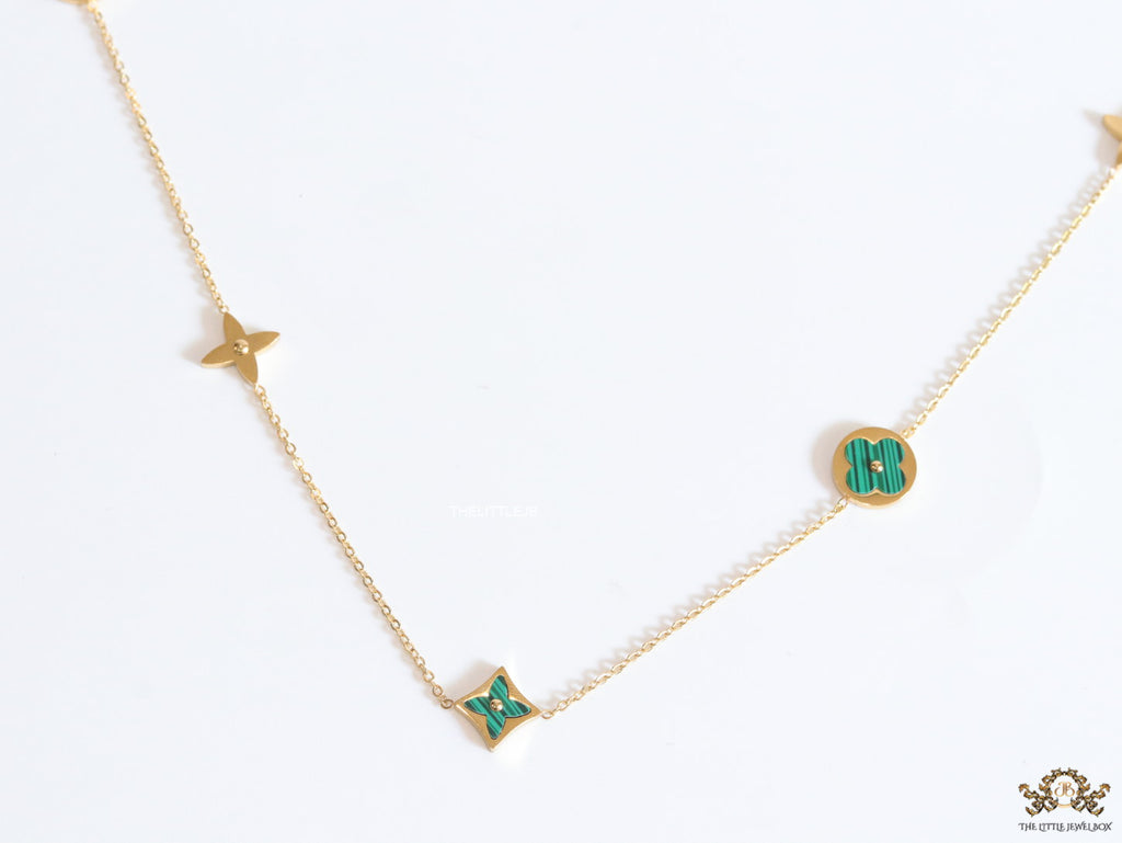 Golden chain necklace with malachite green clovers