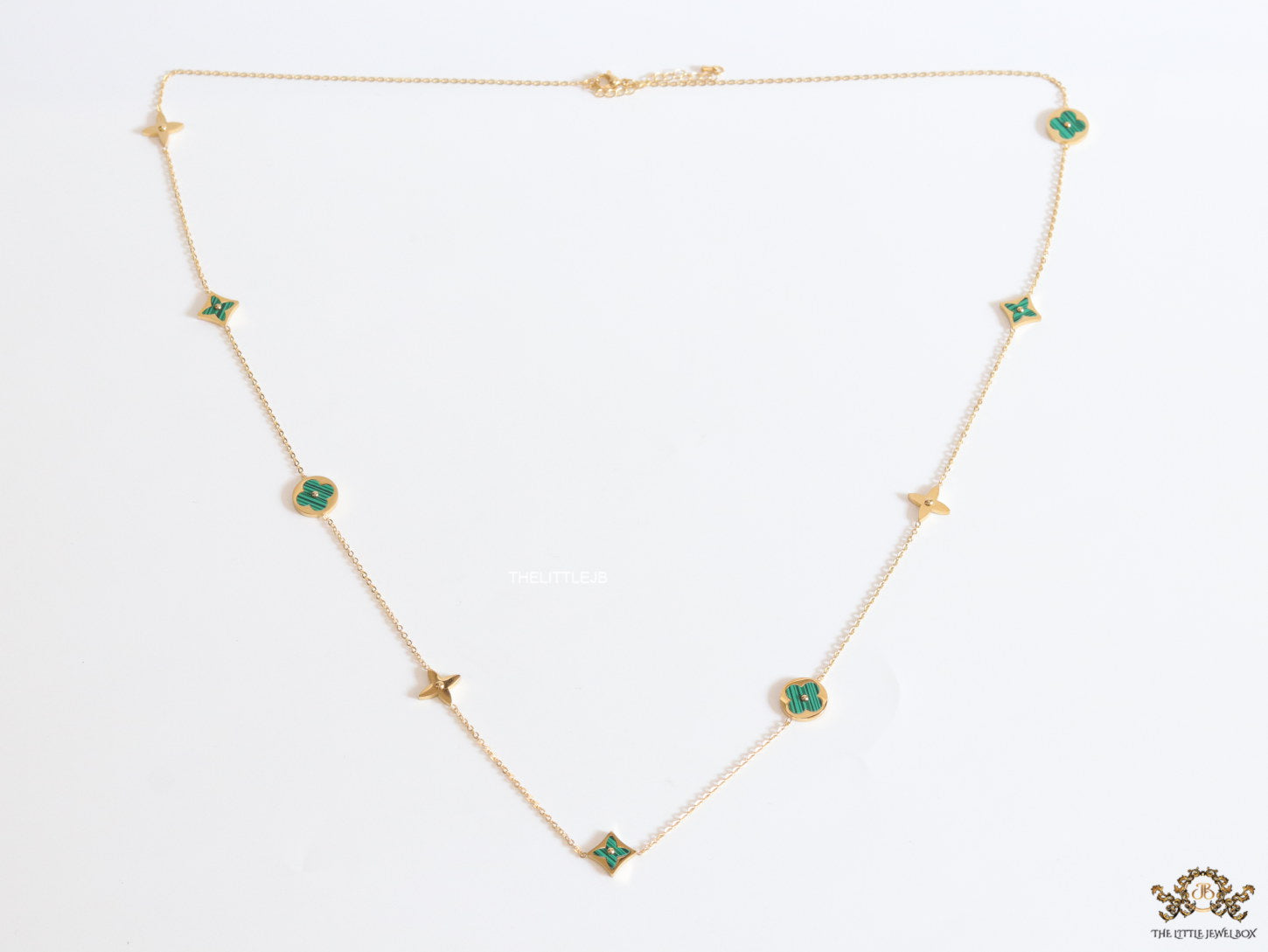 Golden chain necklace with malachite green clovers