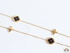 Golden chain necklace with black enamel clovers