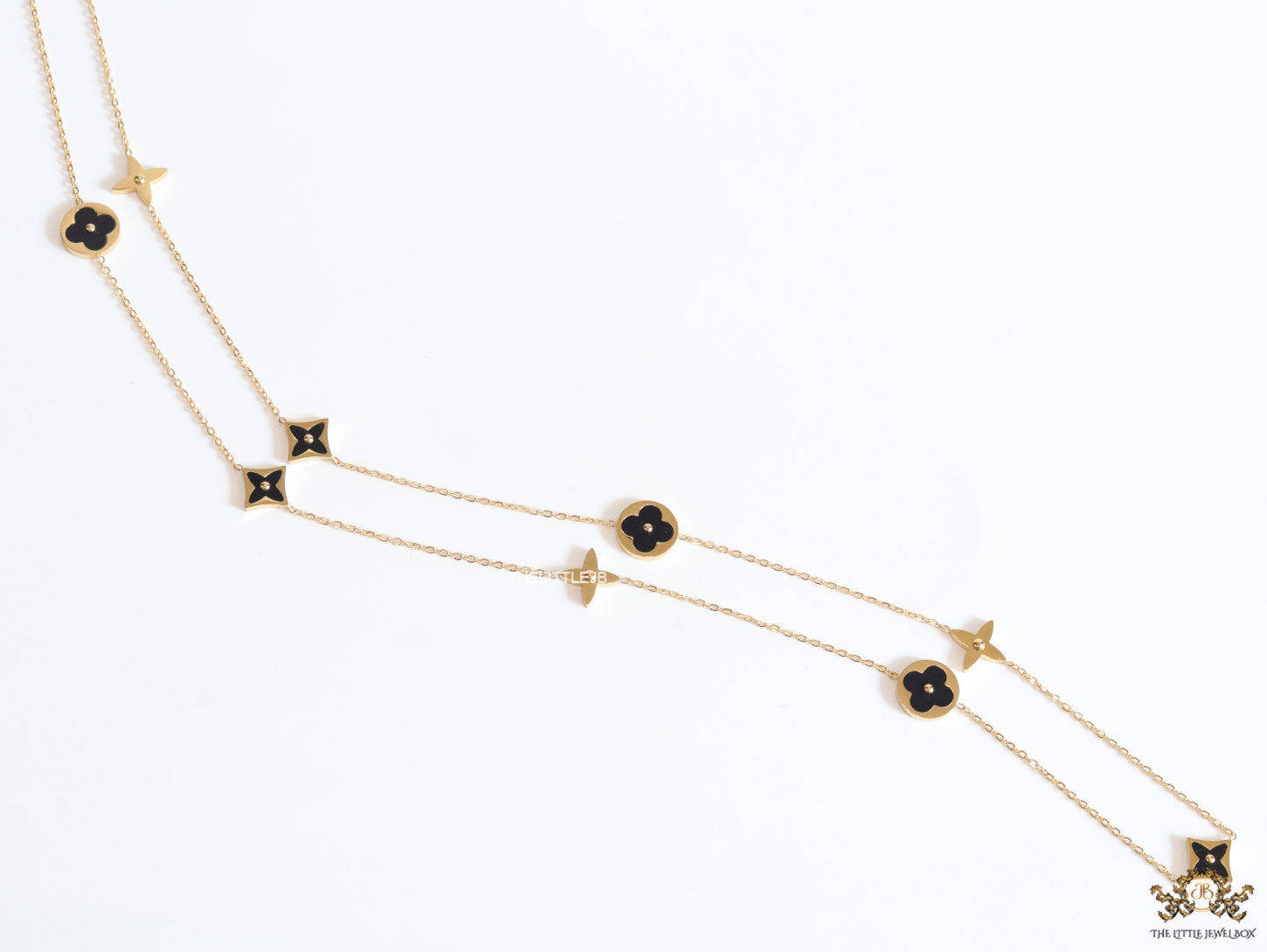 Golden chain necklace with black enamel clovers