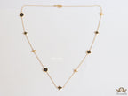 Golden chain necklace with black enamel clovers