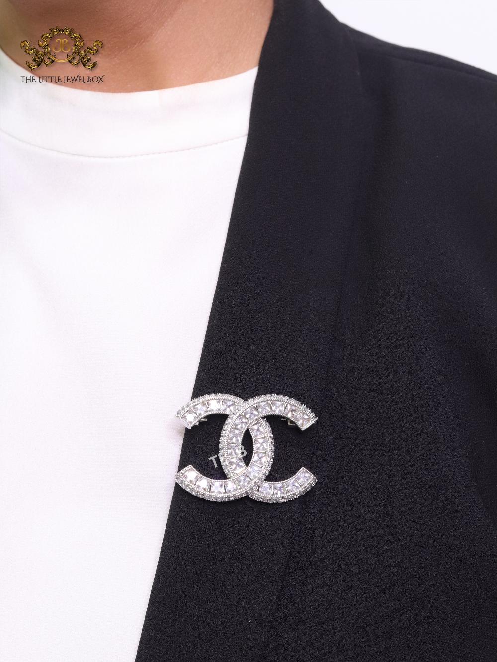 Platinum plated twin C brooch with fancy cut cz