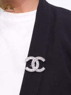 Platinum plated twin C brooch with fancy cut cz