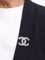 Platinum plated twin C brooch with cz baguettes