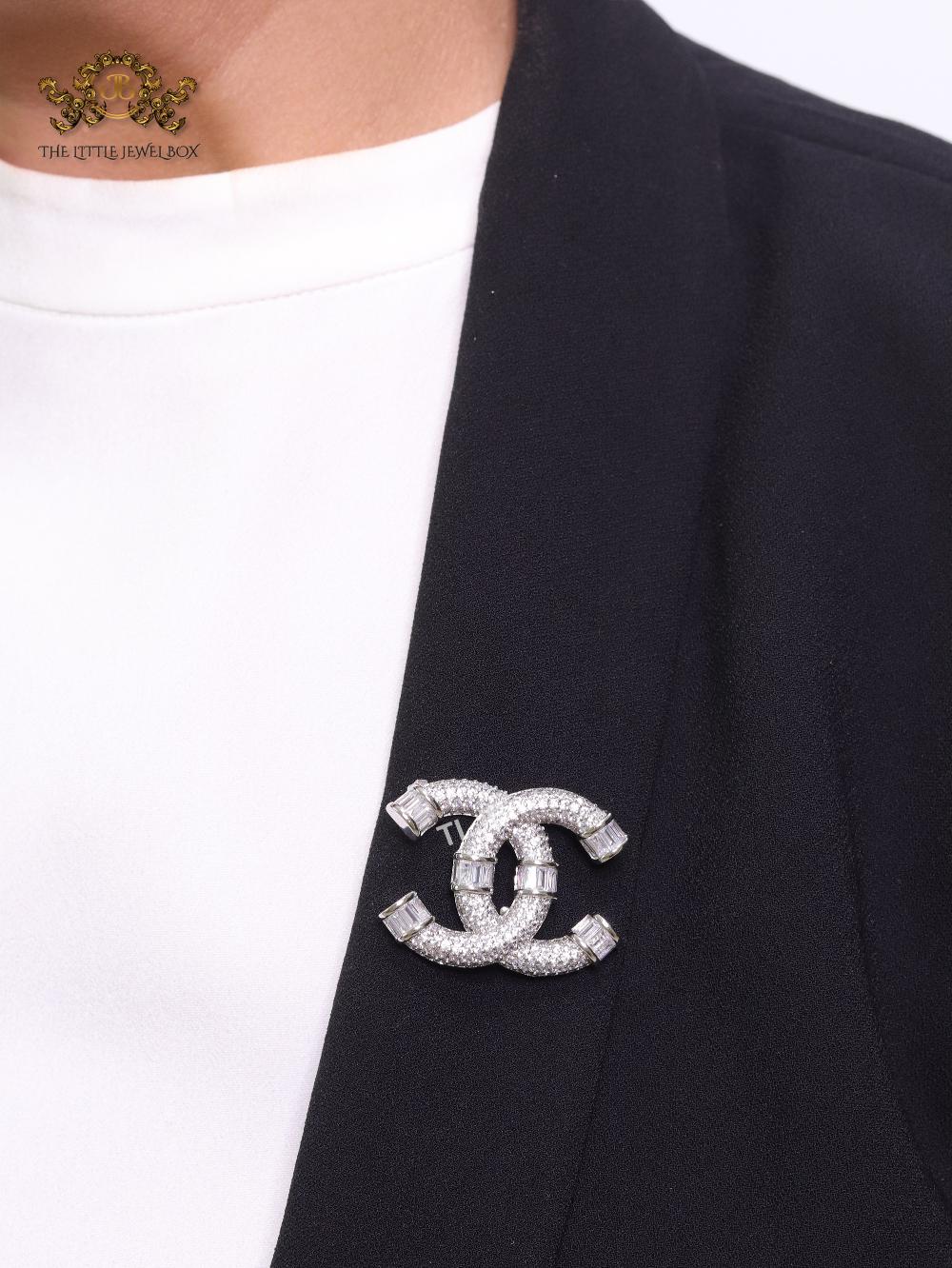 Platinum plated twin C brooch with cz baguettes