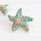 Aqua gold star studs