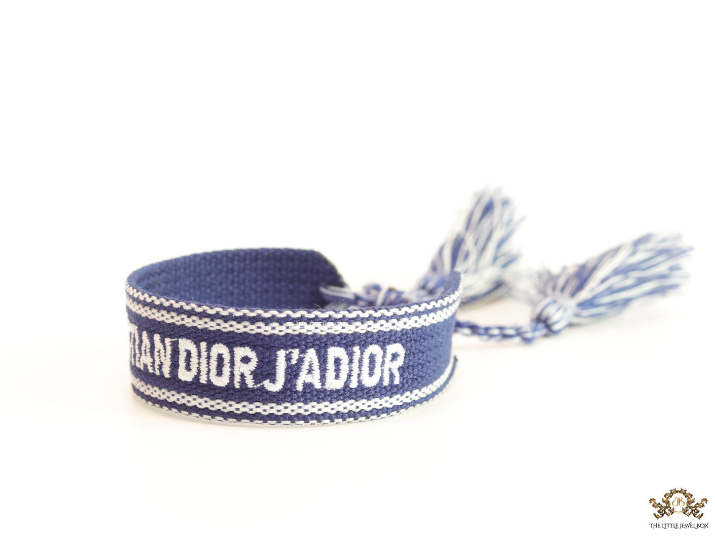 Adjustable blue woven bracelet with white knitted alphabets and tassels